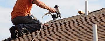 Man on roof with a tool that is securing a new roof in place